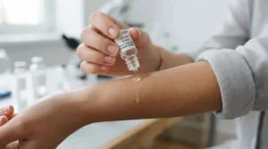A close-up of a person with sensitive skin testing a drop of hypoallergenic perfume for office wear.